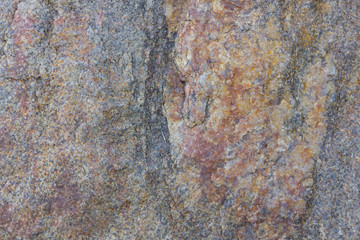 Granite texture close up. Granite rocks with porous surface. Background from solid stone. Pattern with natural material