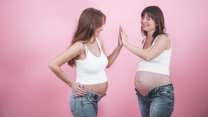 maternity concept, two pregnant women with an open tummy