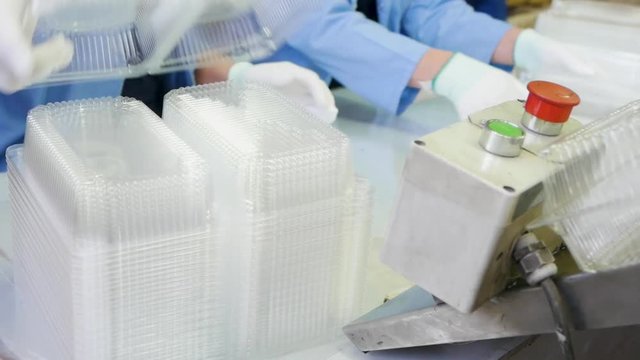 manufacturing of plastic packing Create plastic package and pack. Goods manufactured of plastic packing from environmentally friendly and safe for food storage materials.