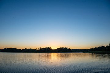 calm weather sunset on country lake
