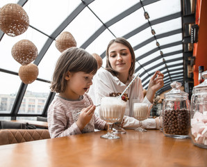 Happy young women mother with children drinking a milkshake