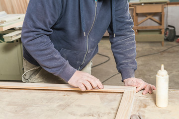 Fototapeta na wymiar Male carpenter working in his carpentry workshop.