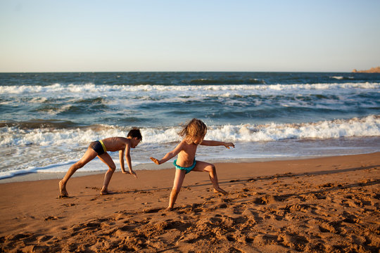 boy and girl on the beach go in for sports