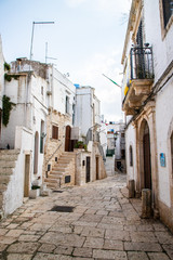 Fototapeta na wymiar Typical alley in beautiful small town of Cisternino, Apulia, South Italy