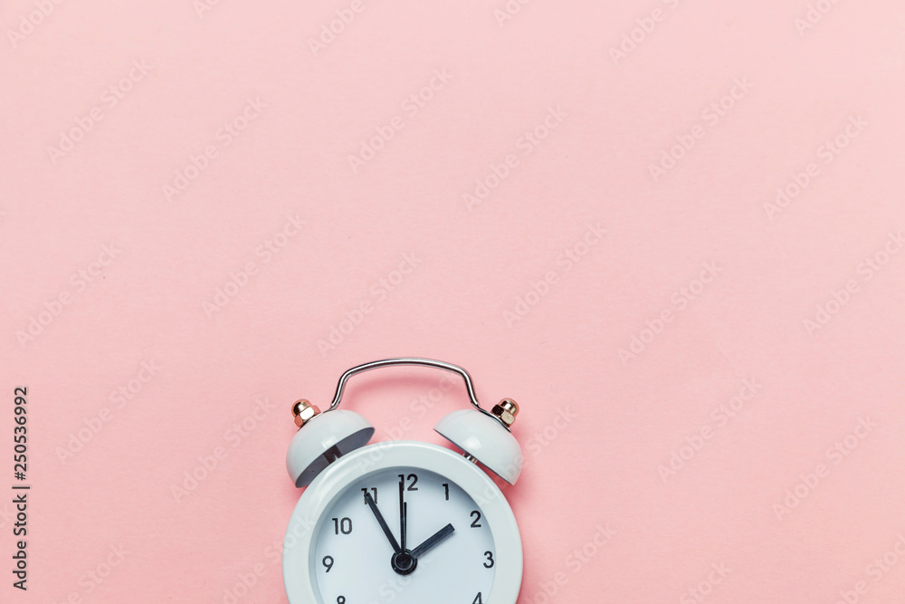 Wall mural Ringing twin bell vintage classic alarm clock Isolated on pink pastel colorful trendy background. Rest hours time of life good morning night wake up awake concept. Flat lay top view copy space