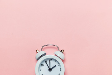 Ringing twin bell vintage classic alarm clock Isolated on pink pastel colorful trendy background. Rest hours time of life good morning night wake up awake concept. Flat lay top view copy space