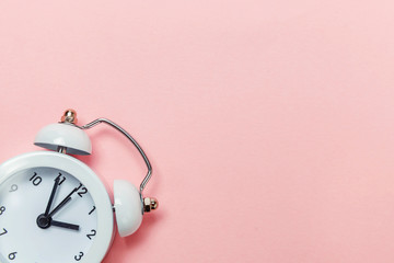 Ringing twin bell vintage classic alarm clock Isolated on pink pastel colorful trendy background....