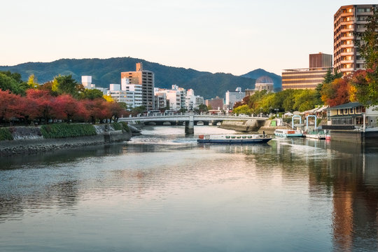 Hiroshima Riverscape at sunset  in Japan with the Peace Memorial Park on the left hand side and ruin of the Atomic Bomb Dome in the background.