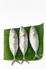 Steamed mackerel fish Put on banana leaf isolated on white background