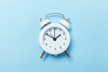 Ringing twin bell vintage classic alarm clock Isolated on blue pastel colorful trendy background....