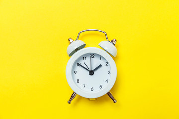 Ringing twin bell vintage classic alarm clock Isolated on yellow colourful trendy modern...