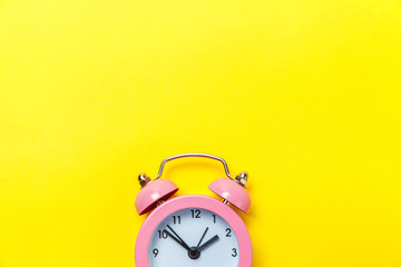 Ringing twin bell vintage classic alarm clock Isolated on yellow colourful trendy modern background. Rest hours time of life good morning night wake up awake concept. Flat lay top view copy space
