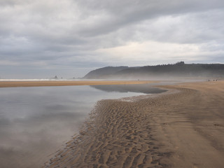 Cannon Beach, Oregon, at extreme low tide on an overcast autumn day.