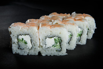 japanese roll sushi with cucumber, cream cheese and tiger shrimp on top