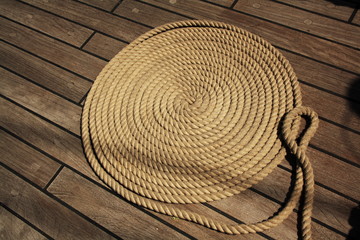 Fototapeta na wymiar Boat rope circles on wooden deck.