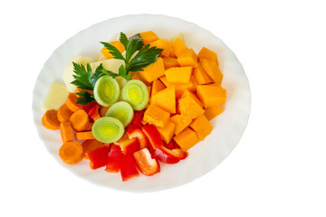 Fresh vegetables on a plate, on a white background.