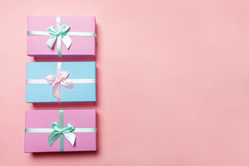 Christmas New Year birthday valentine celebration present romantic concept. Three gift boxes wrapped pink blue paper isolated on pink pastel colorful trendy background. Flat lay top view copy space