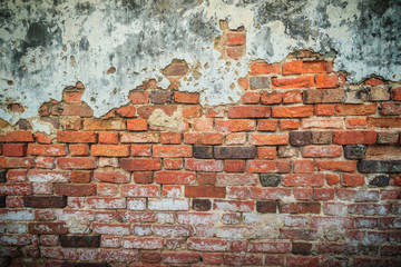 Grungy historical broken brick wall background in sunny summer day. Abstract red brick old wall...