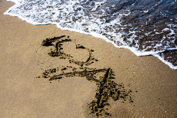 Romantic art on the sand on the beach of the Black sea