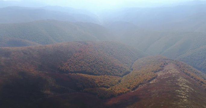 Aerial view: Flying over an amazing autumn mountain near the peak of Gemba. 4k