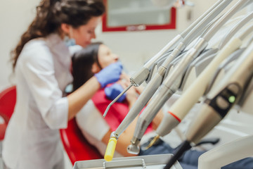A young woman is shocked by the fear of dental instruments that she looks at her, wide-open eyes. The notion of fear of a dentist and dental treatment.