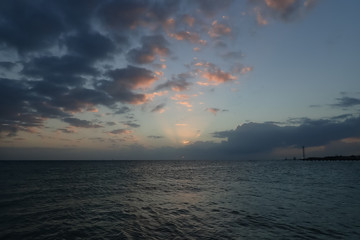 Cloudscape over the ocean and silhouette of Key West, Florida
