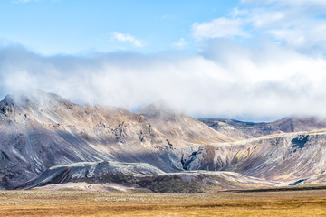 Landscape view of Laugarvatn mountains with clouds covering on golden circle in Iceland during day and blue color sky in autumn
