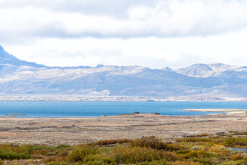 Landscape view of Thingvellir or Laugarvatn mountains and lake with clouds on golden circle in Iceland during day and blue color water in autumn