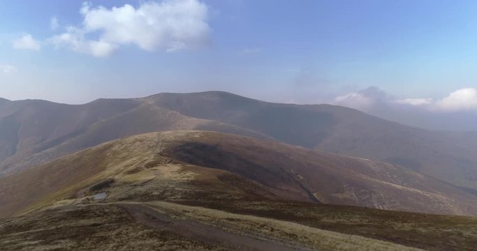 Aerial view: Epic flight along man with beautiful mountains background. 4k