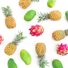 Frame pattern with pineapple, mango and dragon fruits on white background. Flat lay, top view. Food background.
