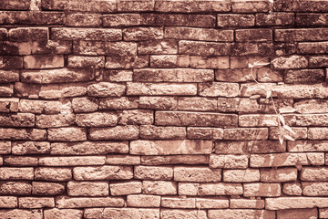 Abstract red brick old wall texture background. Ruins uneven crumbling red brick wall background texture.