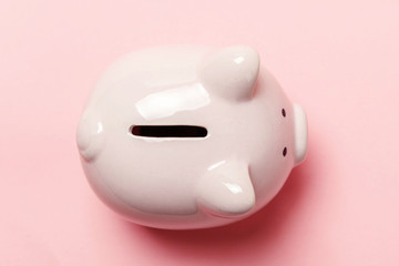Saving investment budget wealth retirement financial money banking concept. Pink piggy bank isolated on pink pastel colourful trendy background. Flat lay top view copy space