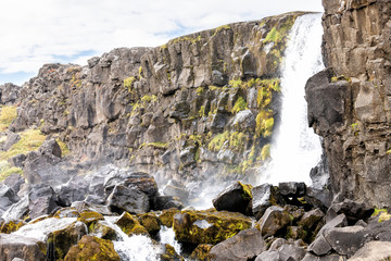 Thingvellir National Park Oxararfoss waterfall rocky landscape on Golden Circle in Iceland with water flowing on rocks river from cliff