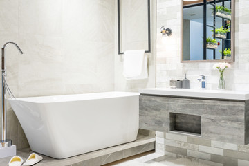 Interior of a contemporary bathroom interior with a white tub and toilet