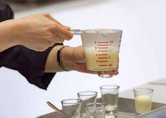 Measuring out milk in a measuring jug for cooking or test