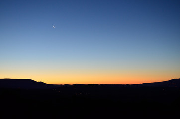sunset with sliver of moon