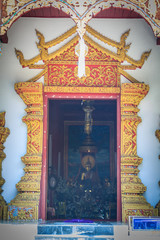 Beautiful golden craved angels in Thai's style church entrance door. Selective focus
