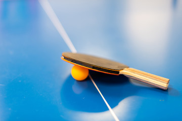 Closeup of ping pong or table tennis racket blue vibrant orange color isolated on top sports game...