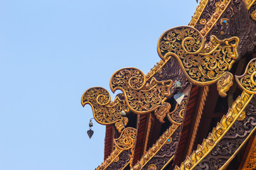 Fototapeta na wymiar Beautiful craved naga pattern on the rafter and gable of the Thai's northern style church at Wat Chedi Liam, one of the ancient temple in the Wiang Kum Kam archaeological area, Chiang Mai, Thailand.