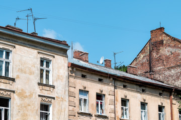 Fototapeta na wymiar Lviv, Ukraine exterior of residential buildings in historic Ukrainian city in old town architecture during day with antenna cables wires power lines hanging and blue sky