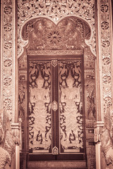 Beautiful golden craved angels in Thai's style church entrance door. Selective focus