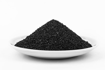 Activated Carbon in the water filter isolated on white background. Activated Carbon on plate.