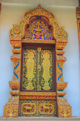 Beautiful Thai's style temple windows with golden craved buddha on the window panels.