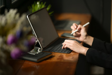Businesswoman working with tablet pc computer in cafe