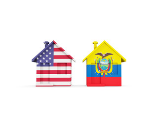 Two houses with flags of United States and ecuador