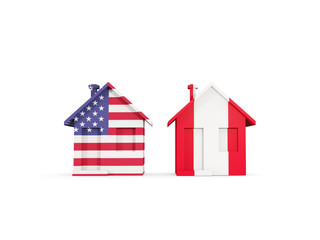 Two houses with flags of United States and peru