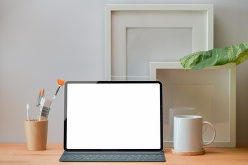 Blank screen tablet with smart keyboard on a office workspace