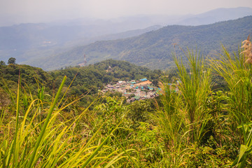 Doi Pui’s Hmong ethnic hill-tribe village, aerial view from the cliff with green forest on the mountain background. Doi Pui Hmong tribal village is located on Doi Suthep-Pui national park, Chiang Mai.