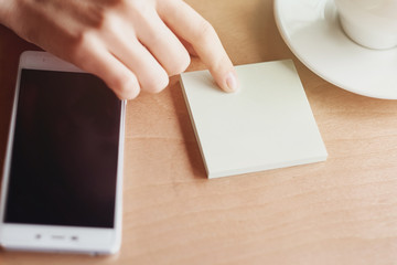 Obraz premium Finger, sticker and smart phone. planning business idea. Close up empty background place for text