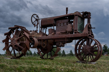 Old farm tractor sitting in a field